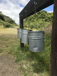 Metallic structure on field against sky