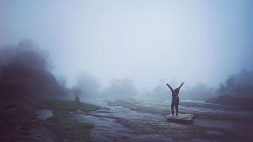 Rear view of man standing on mountain