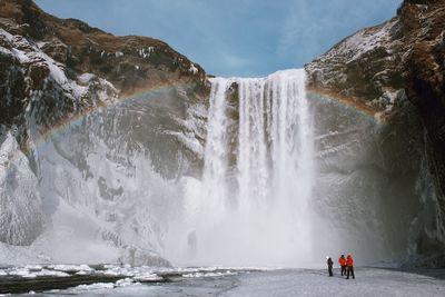 Scenic view of waterfall against sky