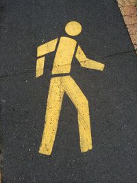 High angle view of pedestrian crossing sign on road