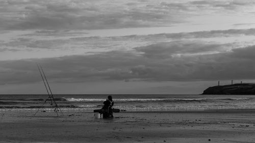 People on beach against sky