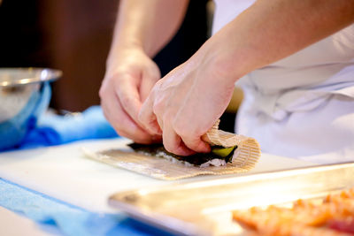 Midsection of man preparing food