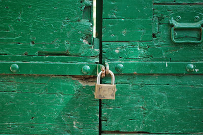 Padlocks and chains in a rusty gate