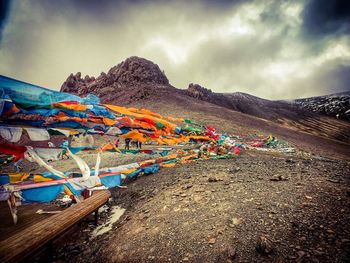 Multi colored umbrellas on land against sky