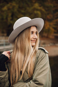 Portrait of young woman in hat