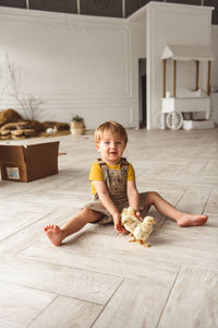 Boy playing with ducks for easter