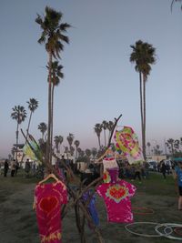 People on beach against clear sky