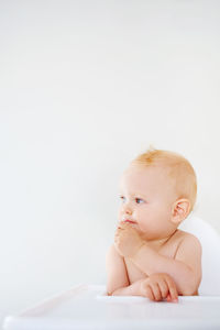 Cute girl looking away while sitting at home