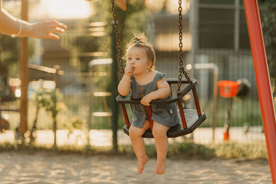 Young woman swinging at playground