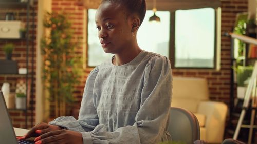 Young woman looking away while sitting in cafe