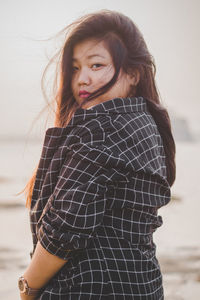 Portrait of young woman standing outdoors