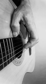 Close-up of man playing guitar