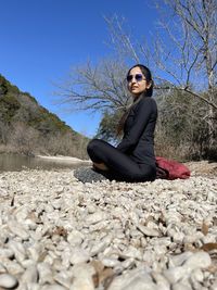 Woman sitting on rocks