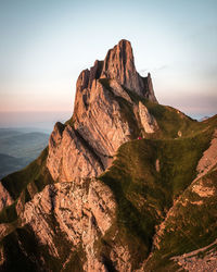 Scenic view of rock formations against sky during sunset