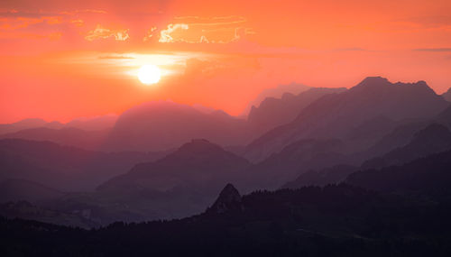 Scenic view of silhouette mountains against sky during sunset