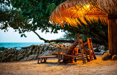 Chairs and table on beach by sea