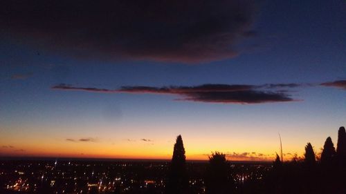 Silhouette buildings against sky during sunset