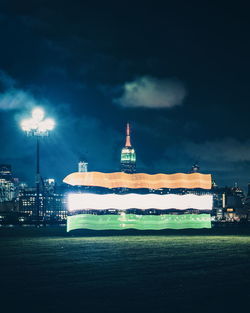 Illuminated building against sky at night