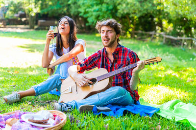 Young couple sitting on grass