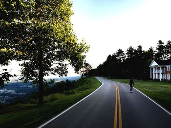 Rear view of person on road against clear sky