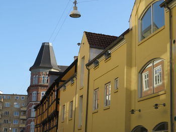Low angle view of buildings against blue sky