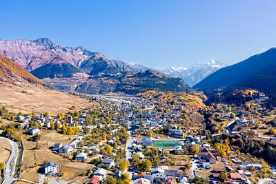 High angle view of houses and mountains against clear sky