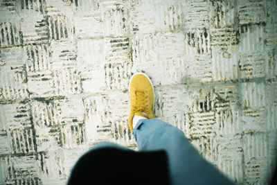 Low section of man standing on floor