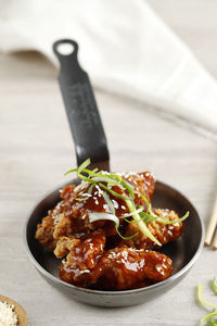 Yangnyeom tongdak, korean style swet, sour, and spicy chicken with sesame seed on top