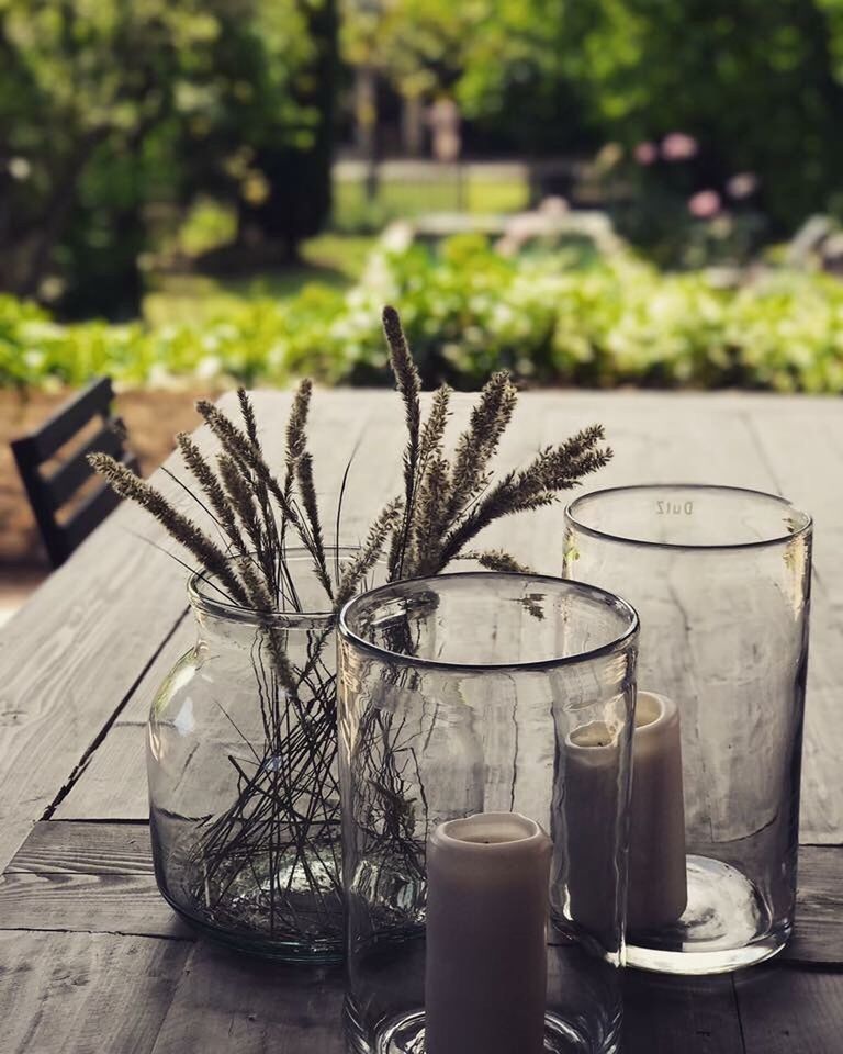 CLOSE-UP OF DRINK ON TABLE AGAINST TREE