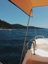 Sailboat sailing on sea against clear sky