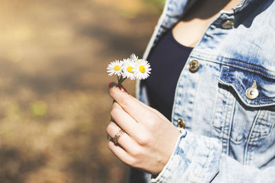 Close-up of woman hand holding flower