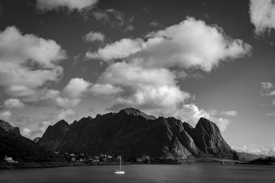 Scenic view of sea and mountains against sky