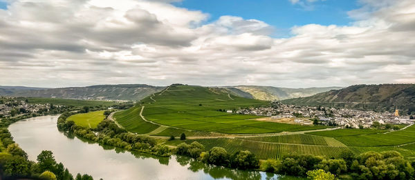 Panoramic shot of agricultural field against sky