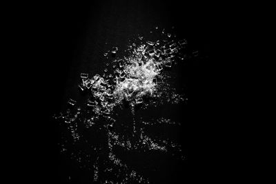 Close-up of firework display over black background