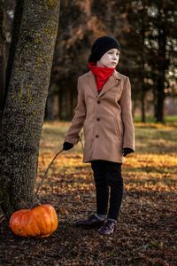 Portrait of young man standing in forest