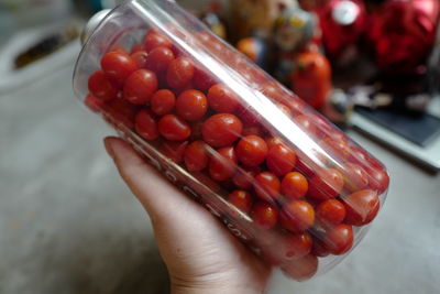 Close-up of hand holding strawberries