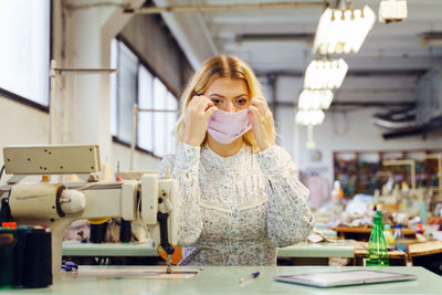 Woman wearing mask in textile factory