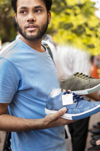 Man choosing shoes in market