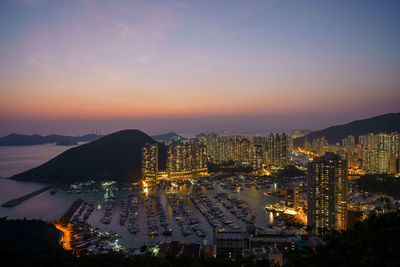 High angle view of illuminated buildings against sky at sunset