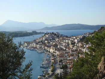 High angle view of townscape by sea against sky