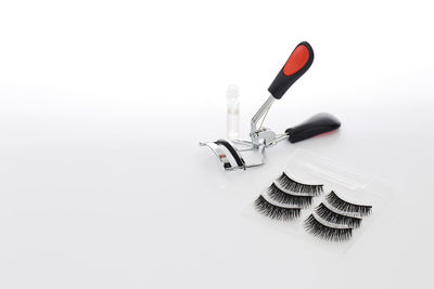 False eyelashes with curler on white background