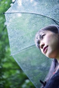 Close-up portrait of a woman in rain