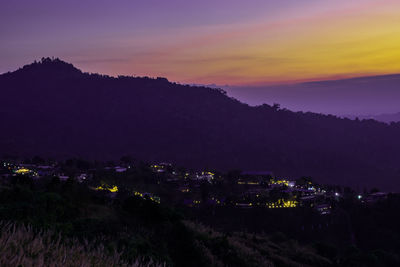 High angle view of illuminated field against sky at sunset