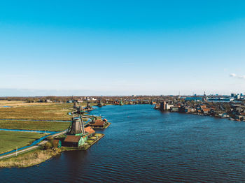 High angle view of buildings in city against clear blue sky