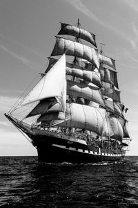 Sailboat in sea against sky