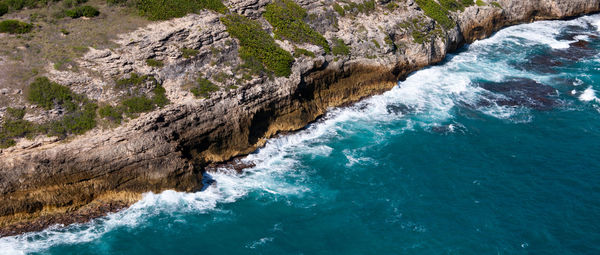 Scenic view of sea by cliff