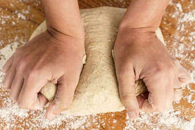 High angle view of hands preparing food