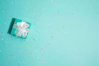 High angle view of gift box on blue background