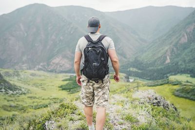 Rear view of man looking at mountains