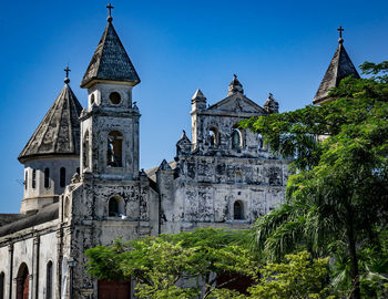 Exterior of old cathedral against clear blue sky